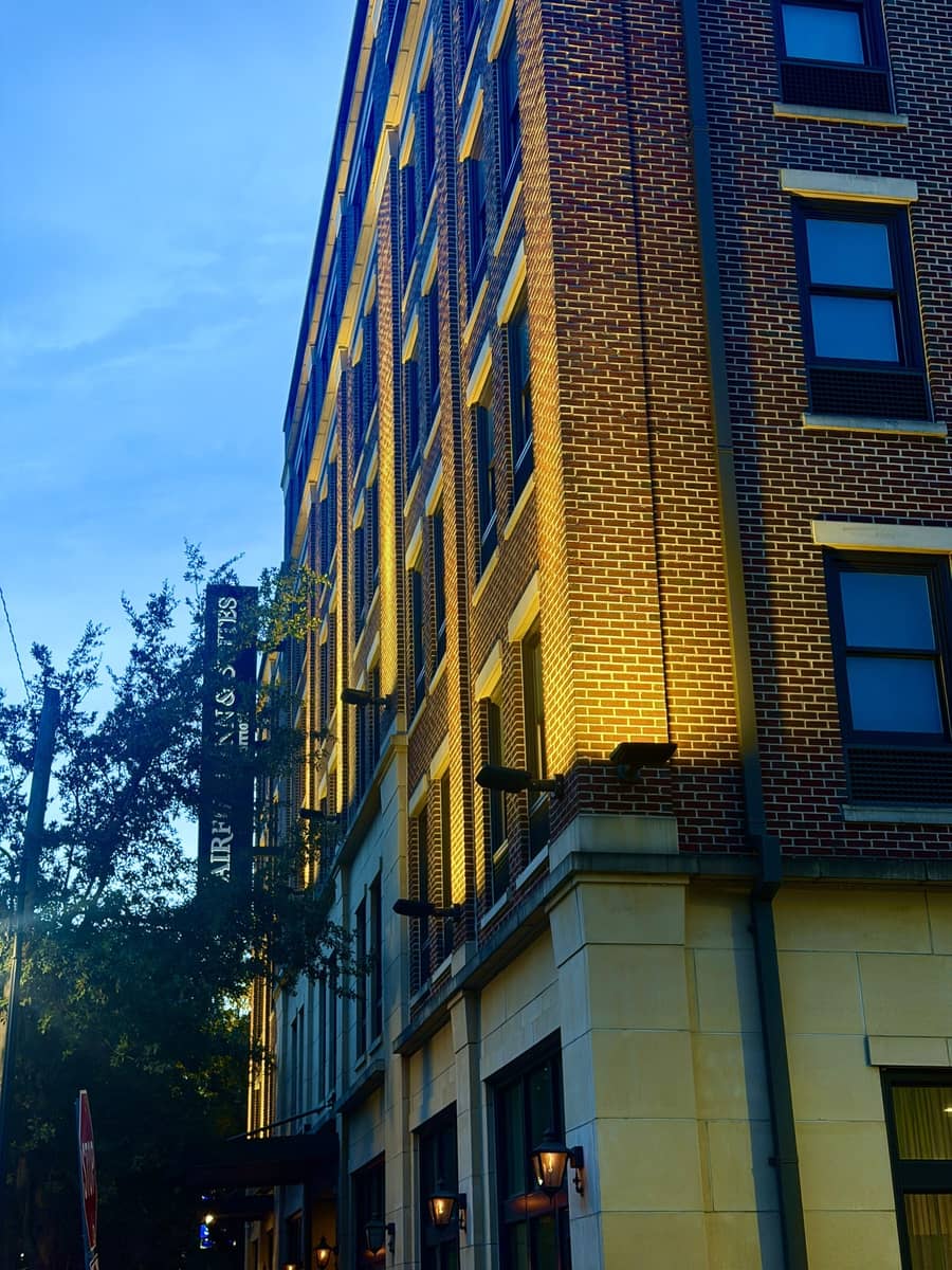 A historic brick building lit at dusk in downtown Savannah, Georgia